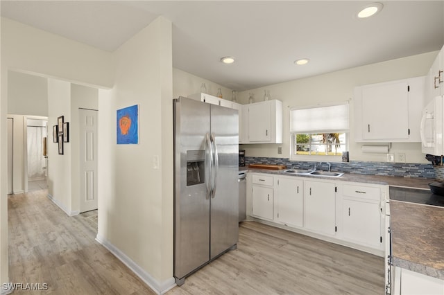 kitchen featuring appliances with stainless steel finishes, sink, and white cabinets