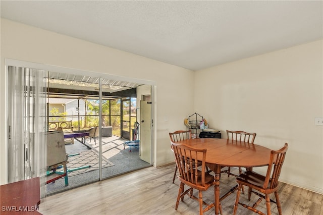 dining room featuring hardwood / wood-style flooring and a textured ceiling