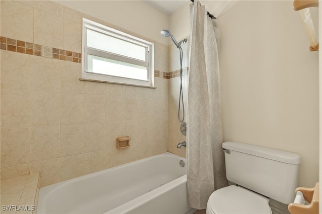 bathroom featuring shower / bath combo and toilet