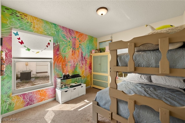 bedroom featuring carpet and a textured ceiling