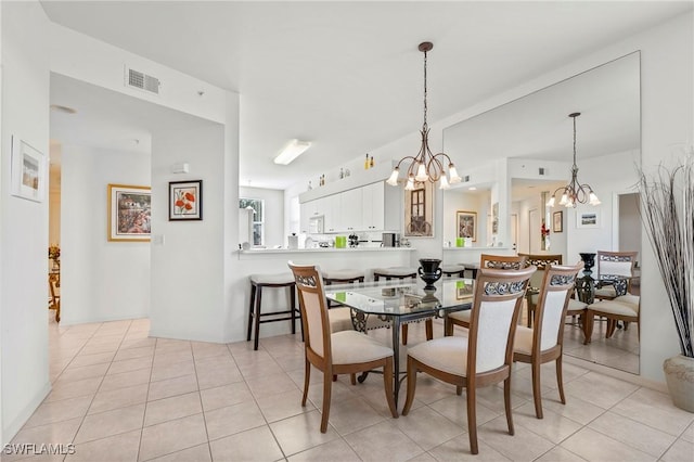 tiled dining space with an inviting chandelier