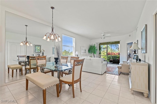 dining area with light tile patterned floors and ceiling fan with notable chandelier