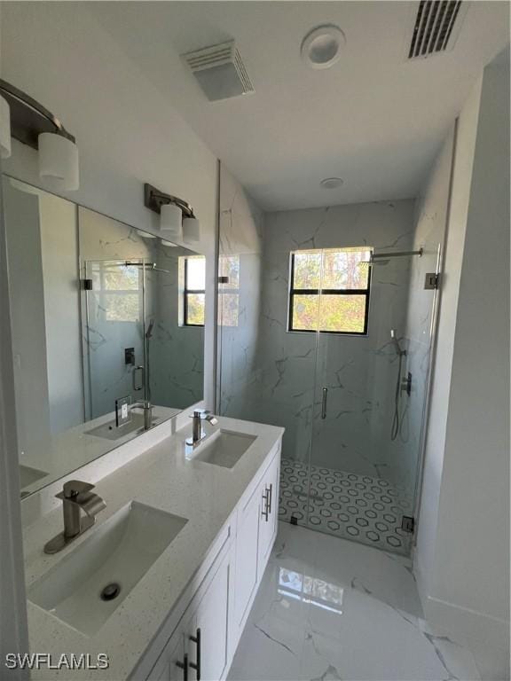 bathroom with marble finish floor, a sink, and visible vents