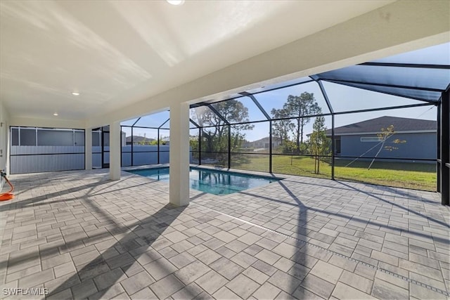 view of swimming pool featuring a patio and a lanai