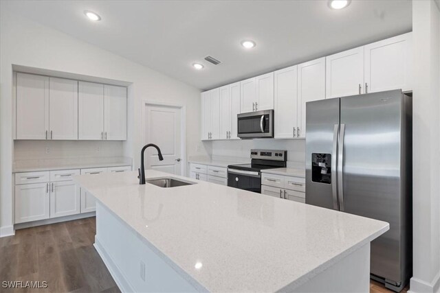 kitchen featuring stainless steel appliances, sink, a center island with sink, and white cabinets