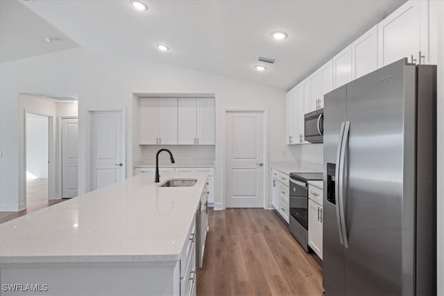 kitchen featuring appliances with stainless steel finishes, sink, a center island with sink, and white cabinets