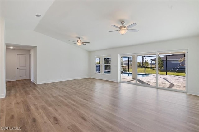 unfurnished living room featuring ceiling fan, lofted ceiling, and light hardwood / wood-style floors