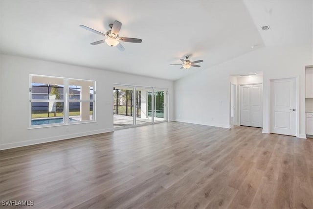 unfurnished living room with vaulted ceiling, light hardwood / wood-style floors, and ceiling fan