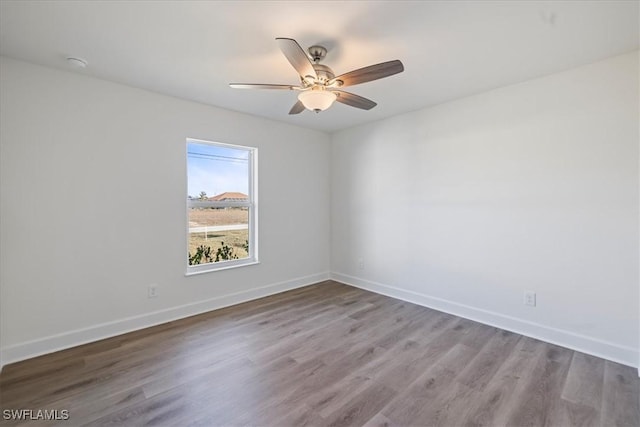 spare room featuring hardwood / wood-style flooring and ceiling fan