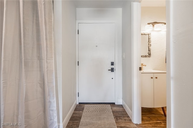 doorway with dark hardwood / wood-style flooring