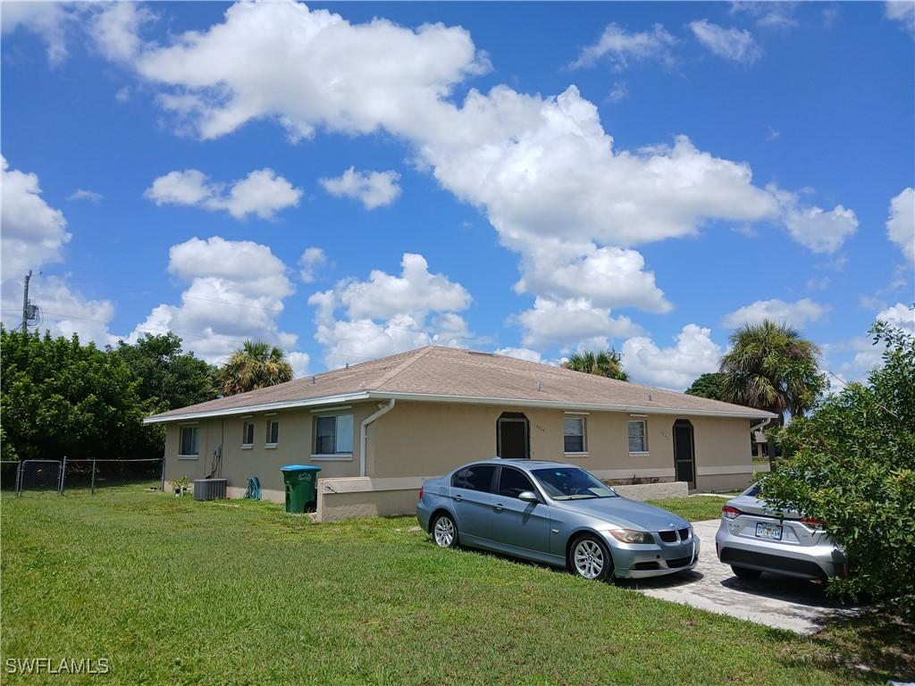 view of front of home featuring cooling unit and a front lawn