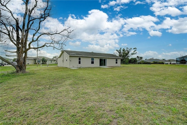 back of property featuring a yard