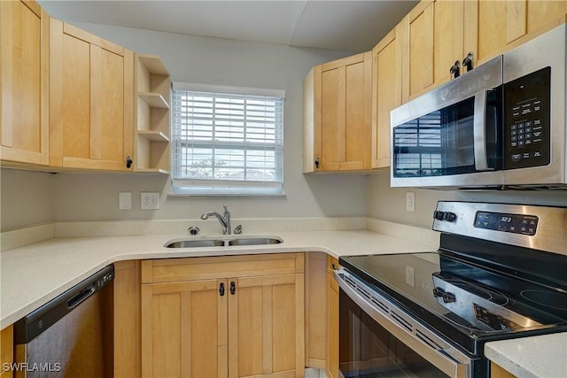 kitchen with light brown cabinetry, sink, and stainless steel appliances