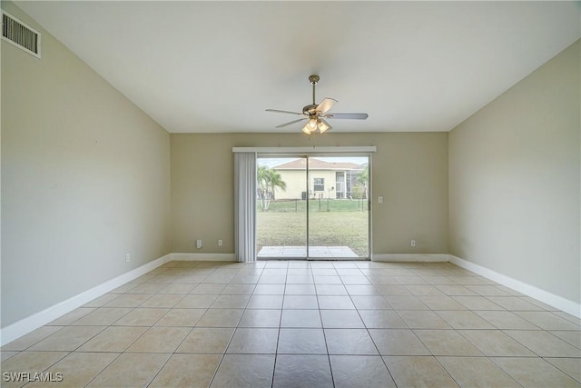 tiled spare room featuring ceiling fan