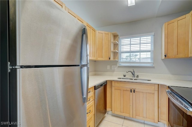 kitchen with light brown cabinetry, sink, light tile patterned floors, and appliances with stainless steel finishes