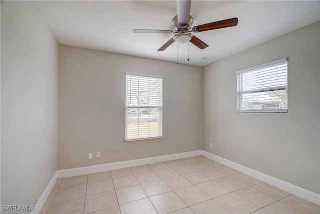 tiled spare room featuring plenty of natural light and ceiling fan