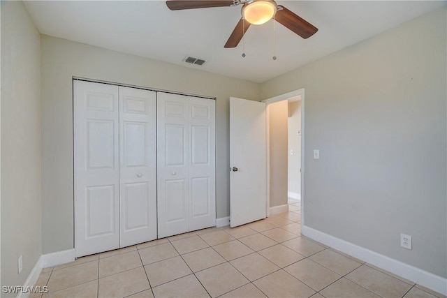 unfurnished bedroom with a closet, ceiling fan, and light tile patterned flooring