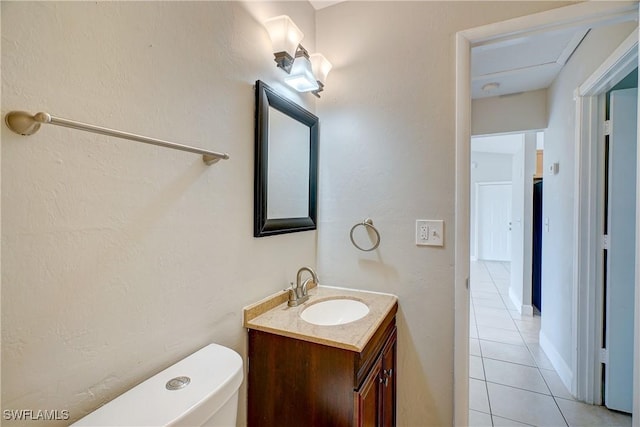 bathroom with vanity, tile patterned floors, and toilet