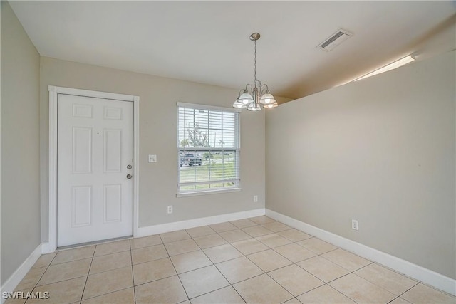 interior space featuring light tile patterned floors and a notable chandelier