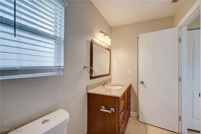 bathroom with vanity, tile patterned floors, and toilet