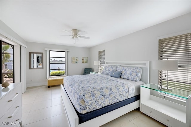 tiled bedroom featuring ceiling fan