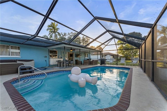 view of pool with a bar, a lanai, a patio area, and a hot tub