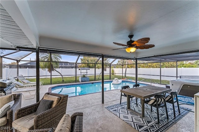 view of pool featuring ceiling fan, a patio, and glass enclosure