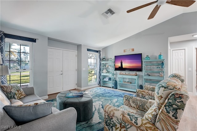 living room featuring hardwood / wood-style floors, vaulted ceiling, a wealth of natural light, and ceiling fan