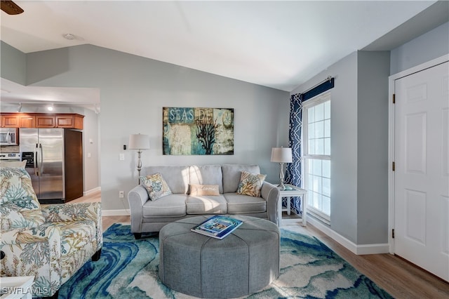 living room with vaulted ceiling and hardwood / wood-style floors