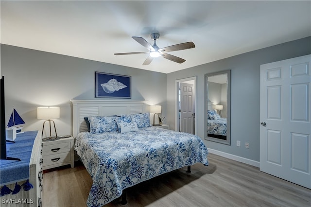 bedroom with wood-type flooring and ceiling fan