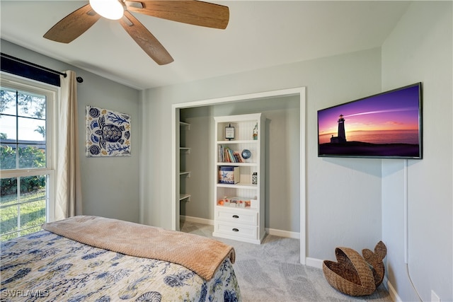 bedroom with ceiling fan and light carpet