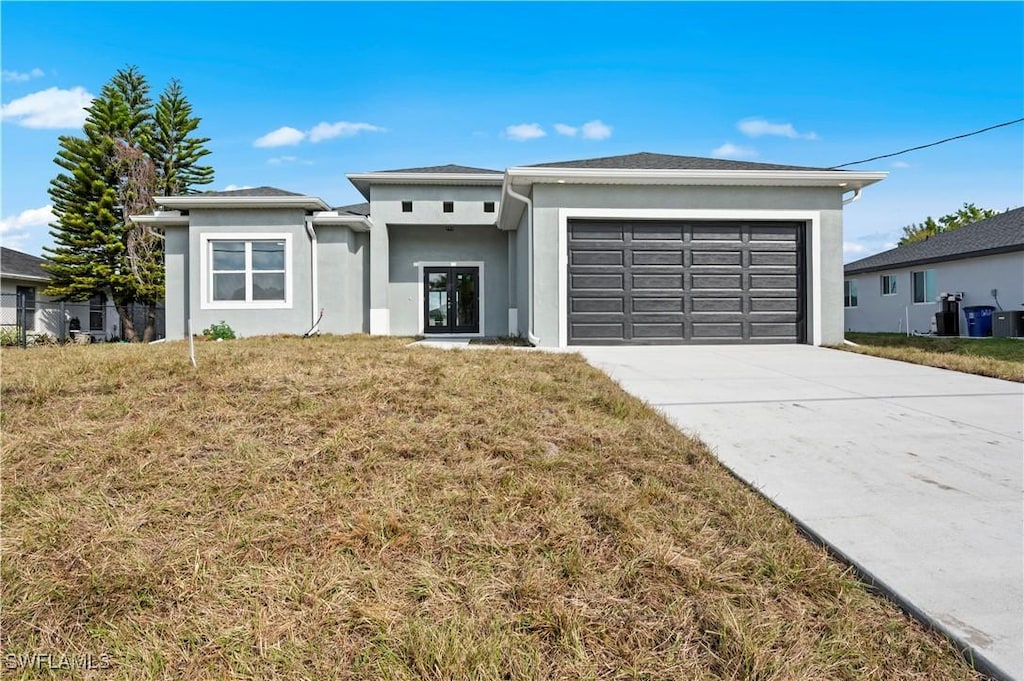 view of front of property featuring a garage and a front lawn