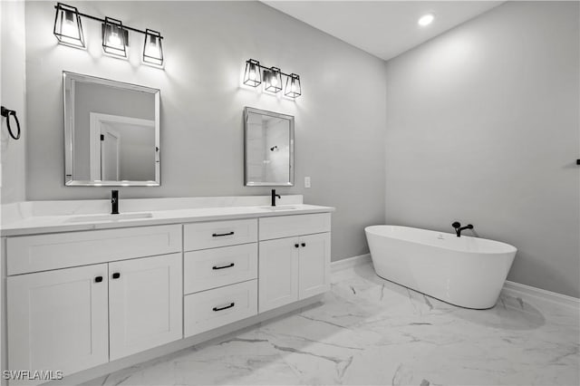 bathroom featuring vanity and a washtub