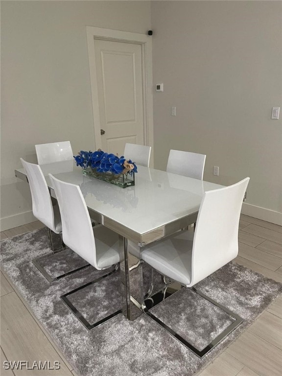 dining space featuring light wood-type flooring