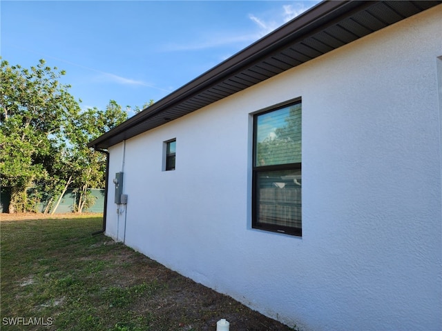 view of side of home with a lawn