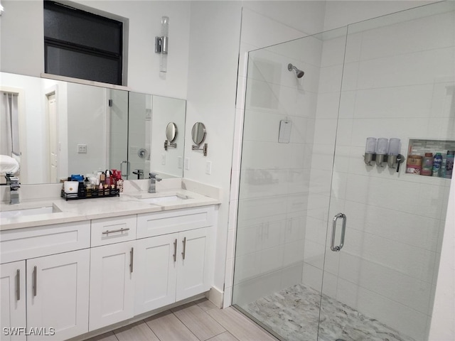 bathroom featuring vanity and an enclosed shower