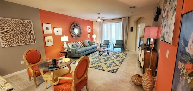 tiled living room with ceiling fan