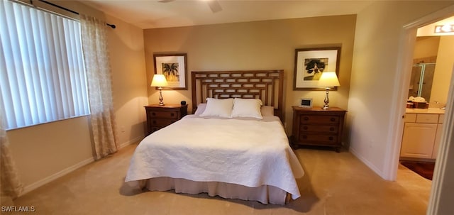 carpeted bedroom with ceiling fan and ensuite bath