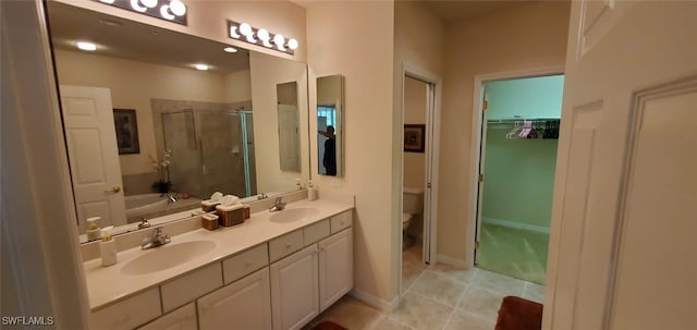 full bathroom featuring toilet, tile patterned floors, plus walk in shower, and vanity