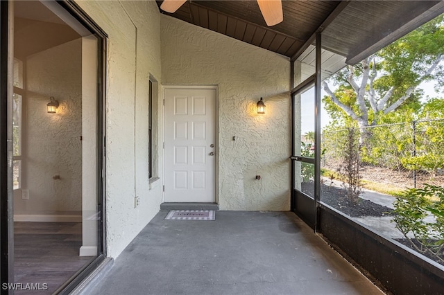 unfurnished sunroom featuring ceiling fan and lofted ceiling