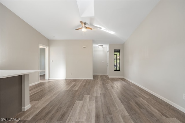 unfurnished living room with ceiling fan, wood-type flooring, and lofted ceiling