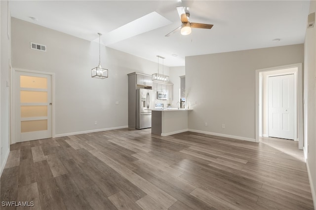 unfurnished living room with dark wood-type flooring and ceiling fan