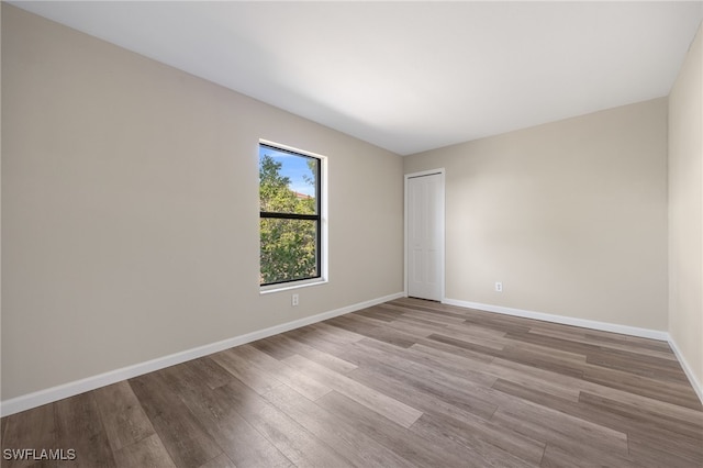 spare room featuring light hardwood / wood-style flooring