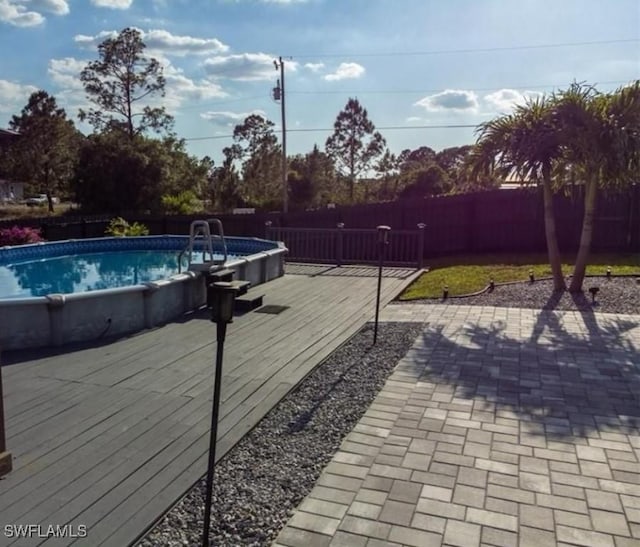 view of swimming pool with a wooden deck