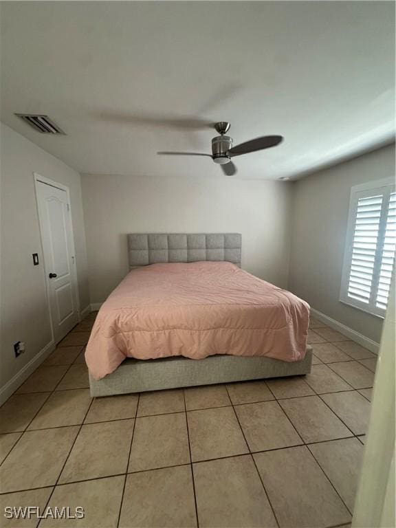 bedroom with light tile patterned flooring and ceiling fan