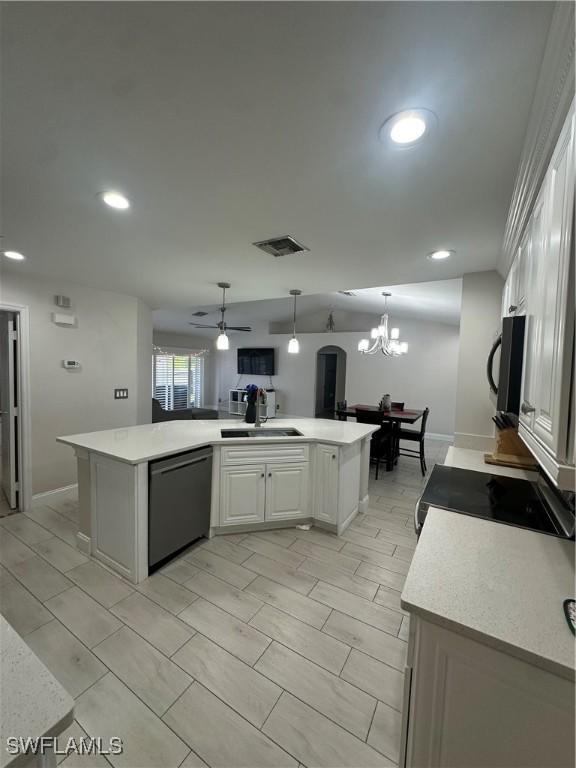 kitchen featuring sink, white cabinetry, black appliances, an island with sink, and decorative light fixtures