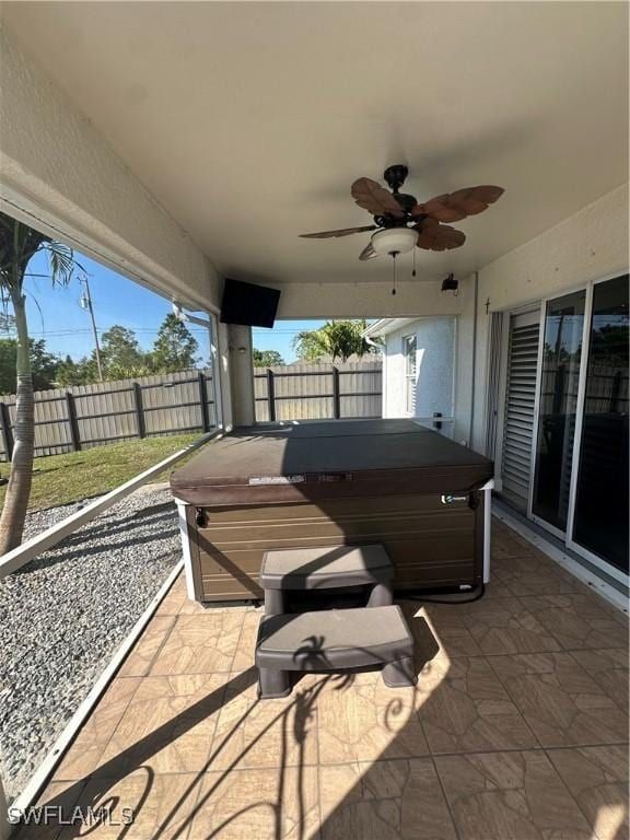 view of patio / terrace with a hot tub and ceiling fan