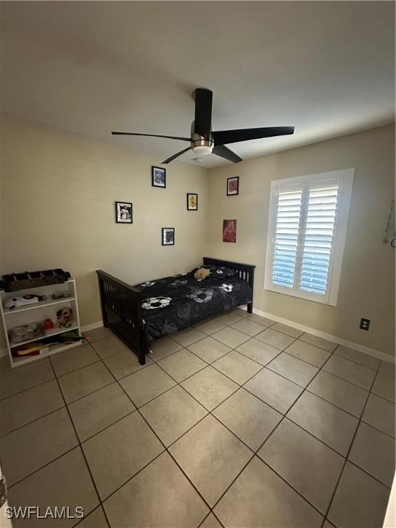 tiled bedroom with ceiling fan