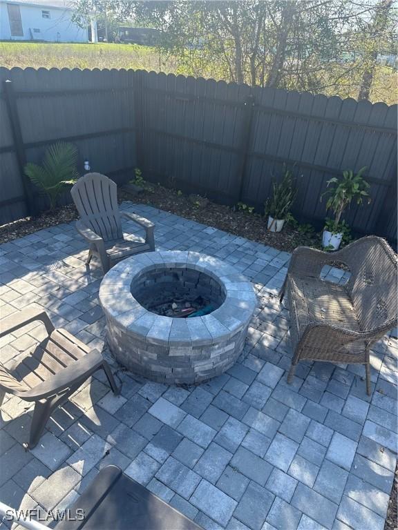 view of patio with a fire pit