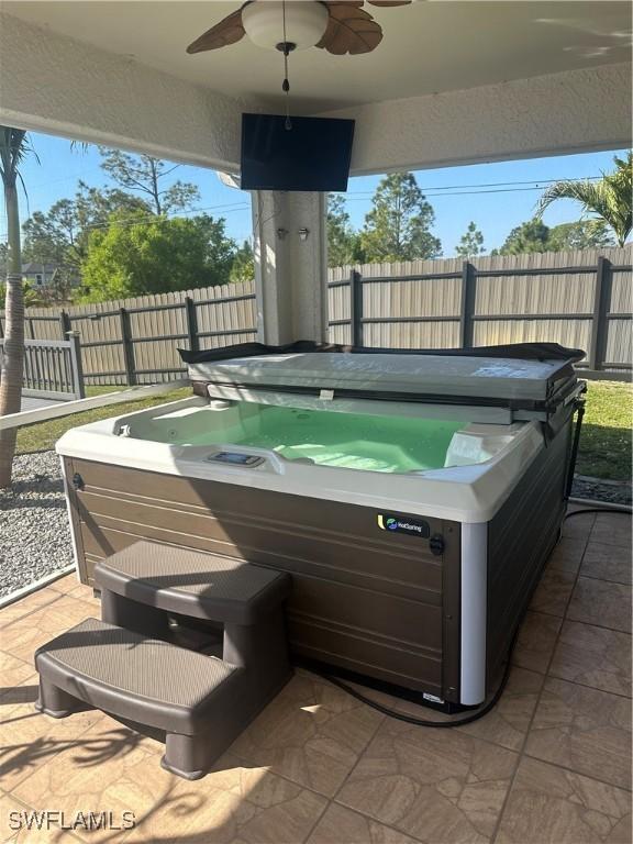 view of patio with a hot tub and ceiling fan